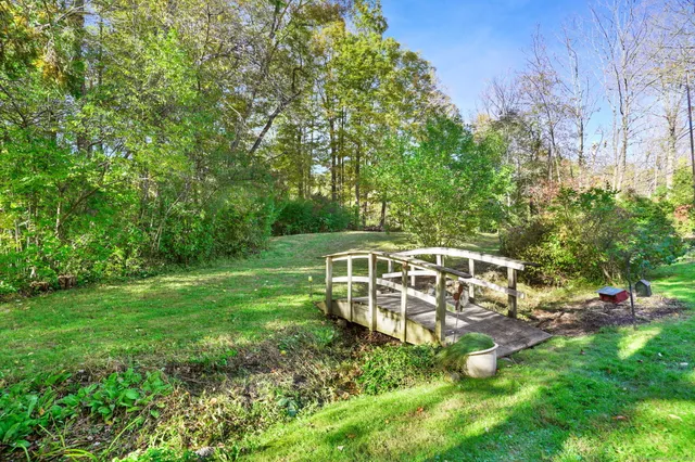 a view of a house with a backyard