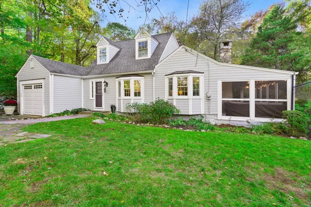 a front view of house with yard and green space