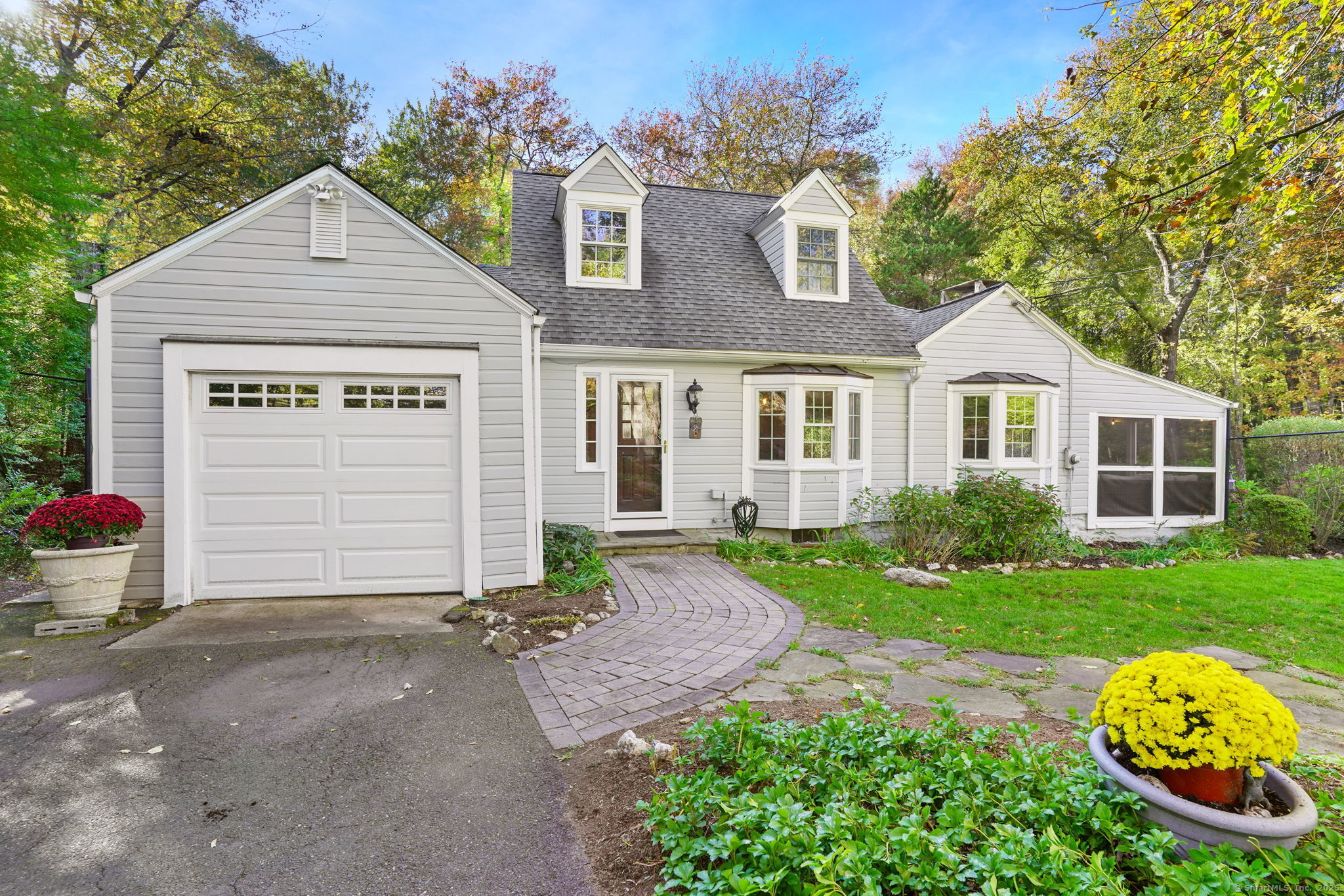 477 Newtown Turnpike Redding, CT 06896 - Photo 34 of 38 a front view of a house with a yard and garage
