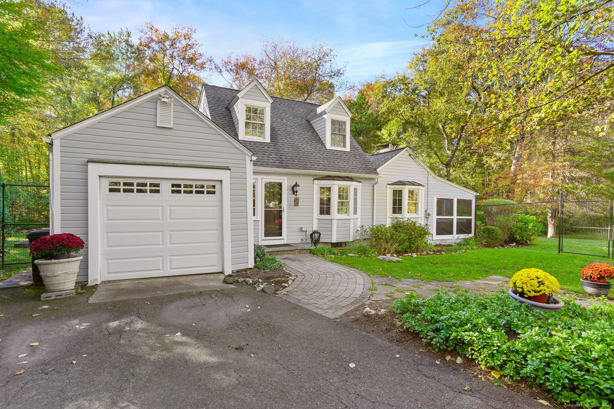 477 Newtown Turnpike Redding, CT 06896 - Photo 35 of 38 a front view of a house with garden