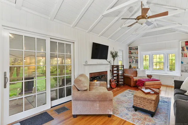 a living room with furniture a fireplace and a flat screen tv