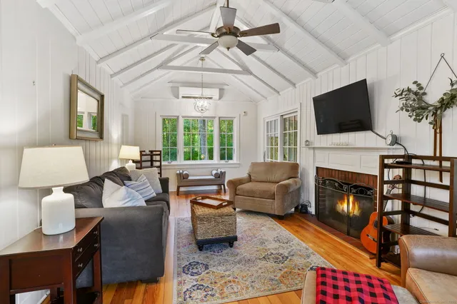 a living room with furniture fireplace and flat screen tv