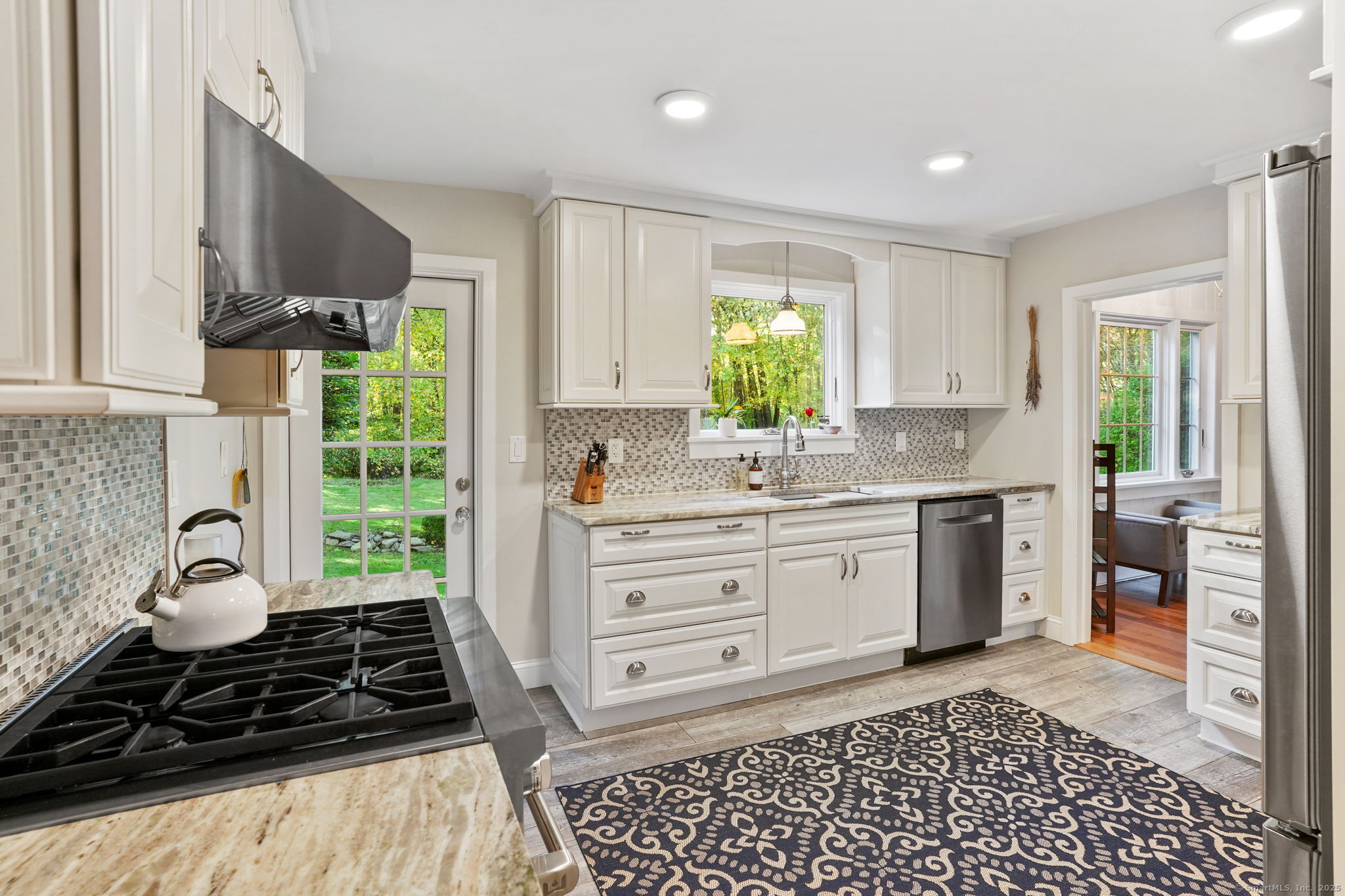 477 Newtown Turnpike Redding, CT 06896 - Photo 10 of 38 a kitchen with a stove a sink and a window