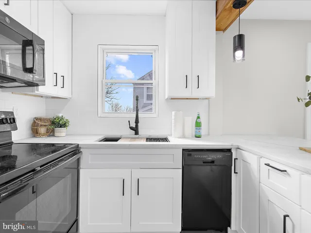 a kitchen with stainless steel appliances granite countertop a sink stove and cabinets