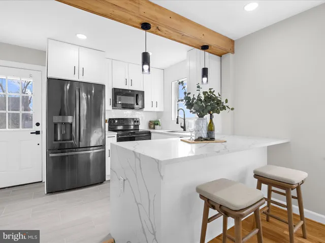 a kitchen with stainless steel appliances a refrigerator and a stove