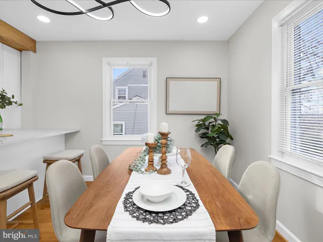 a dining room with furniture and a wooden floor