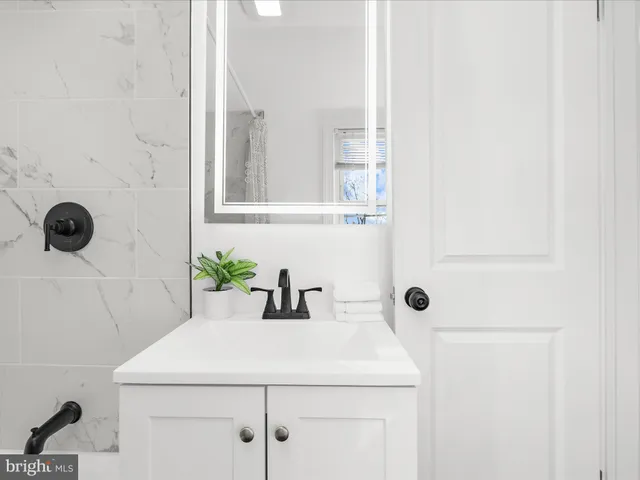 a bathroom with a sink and mirror