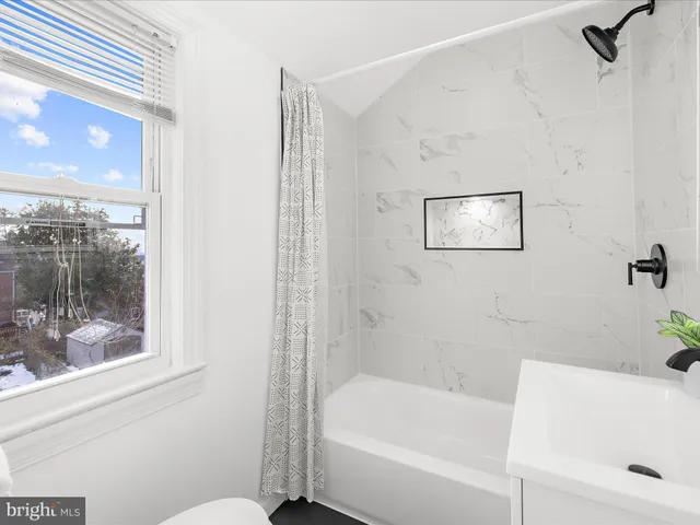 a bathroom with a bathtub and shower