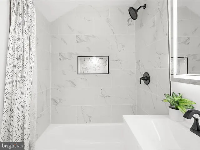 a bathroom with a bathtub and shower