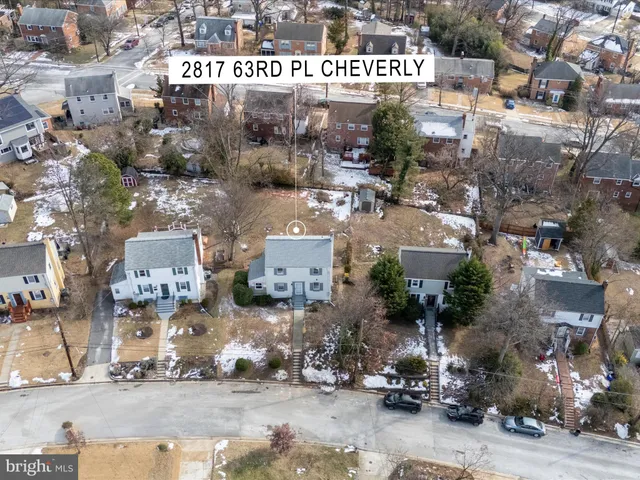 an aerial view of a house with a yard and trees
