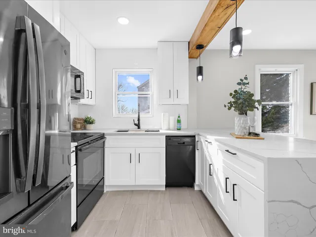 a kitchen with granite countertop a sink stove and refrigerator