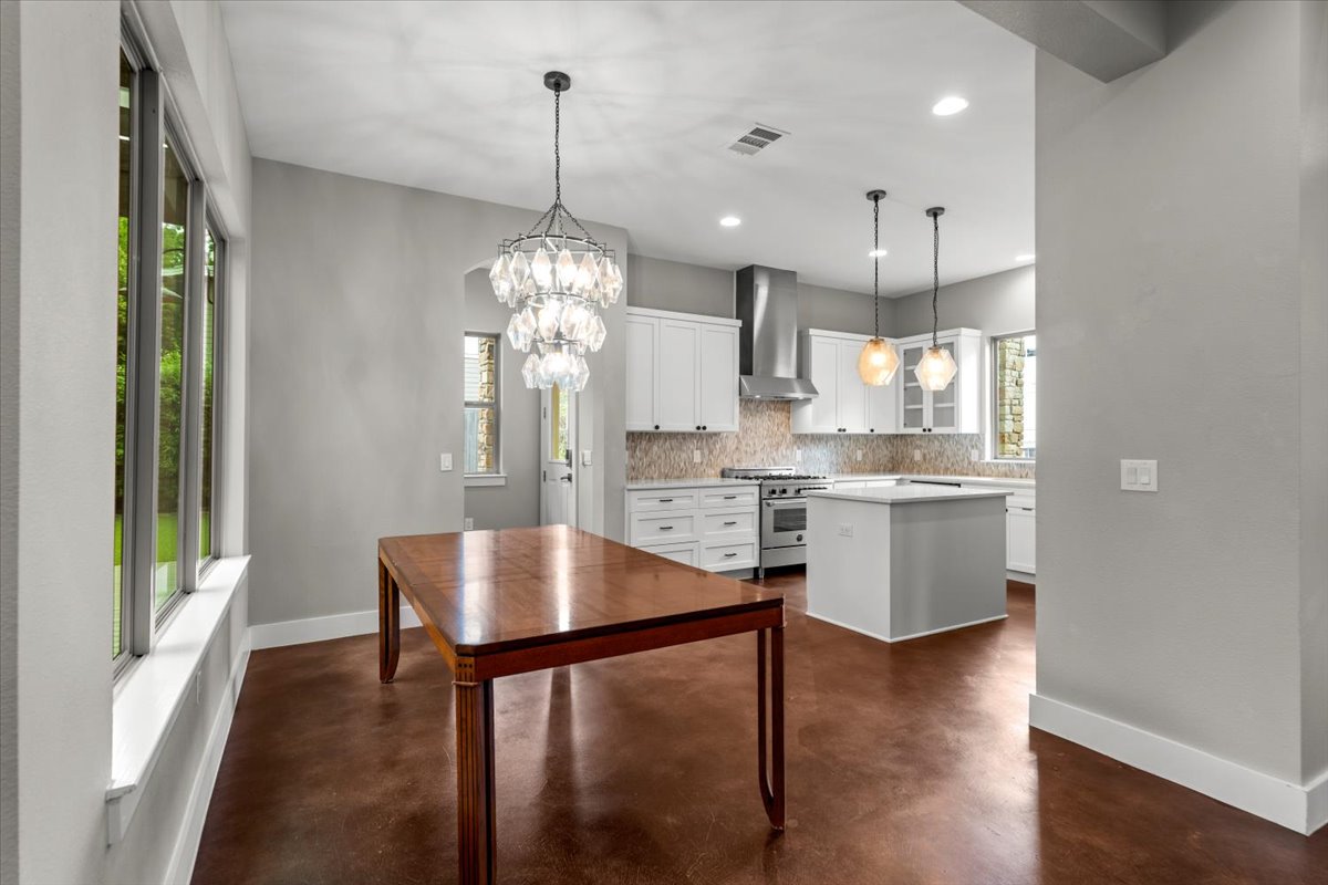 913 Stobaugh Street, Unit B Austin, TX 78757 - Photo 13 of 40 An open-concept living area with lustrous flooring connects the dining space and gourmet kitchen. (Note: dining table will be removed)