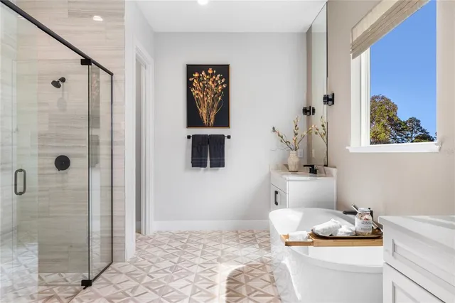 a bedroom with bed and a painting on the wall