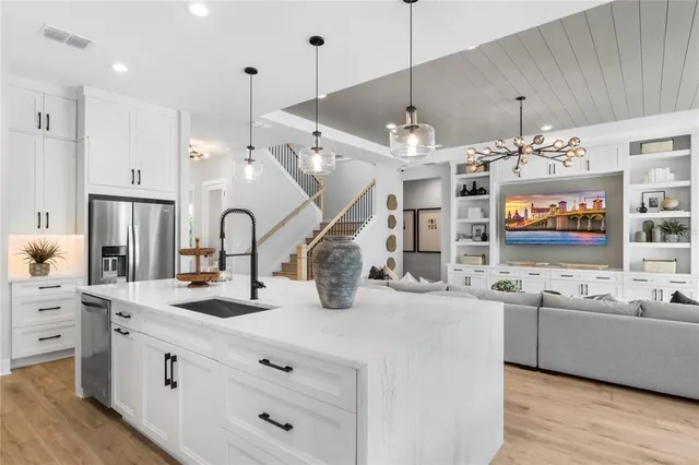 a dining room with furniture a large window and wooden floor