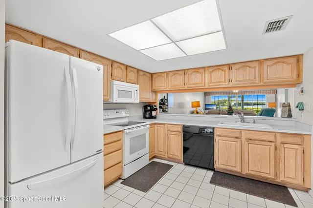 a kitchen with stainless steel appliances granite countertop a refrigerator sink and cabinets