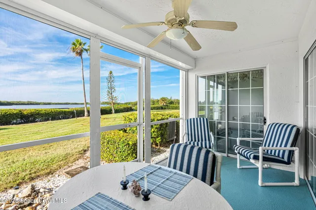a view of a bedroom with furniture and balcony