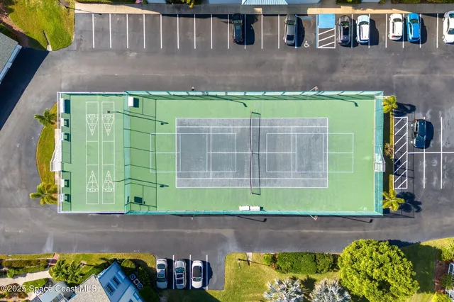 a green field with some trees in the background