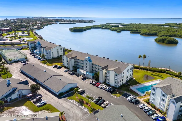 an aerial view of a house with a swimming pool and outdoor seating