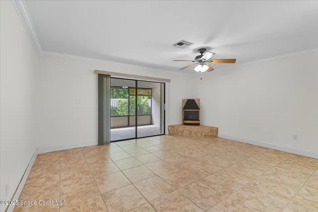 a view of a room with a ceiling fan and a window