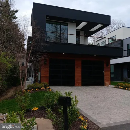 a view of a house with a small yard and plants
