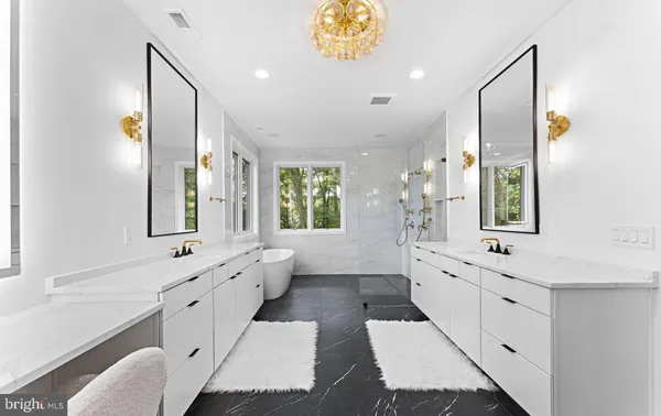 a spacious bathroom with a double vanity sink large mirror and a bathtub