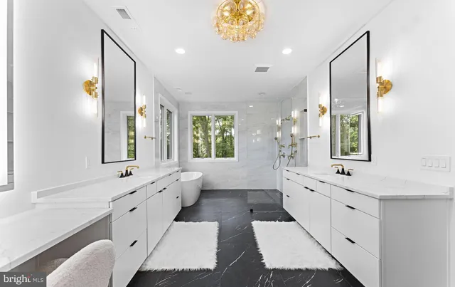 a spacious bathroom with a double vanity sink large mirror and a bathtub