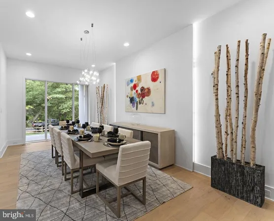 a dining room with furniture and a large window