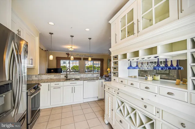 a kitchen with stainless steel appliances kitchen island granite countertop a sink and cabinets
