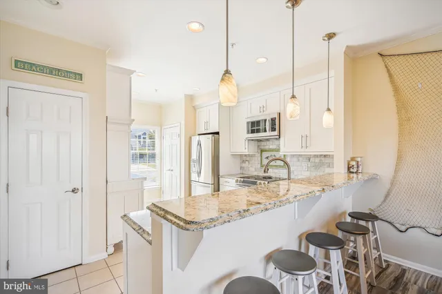 a kitchen with granite countertop sink and cabinets
