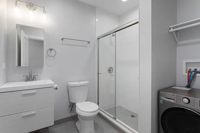a bathroom with a toilet a sink and a shower