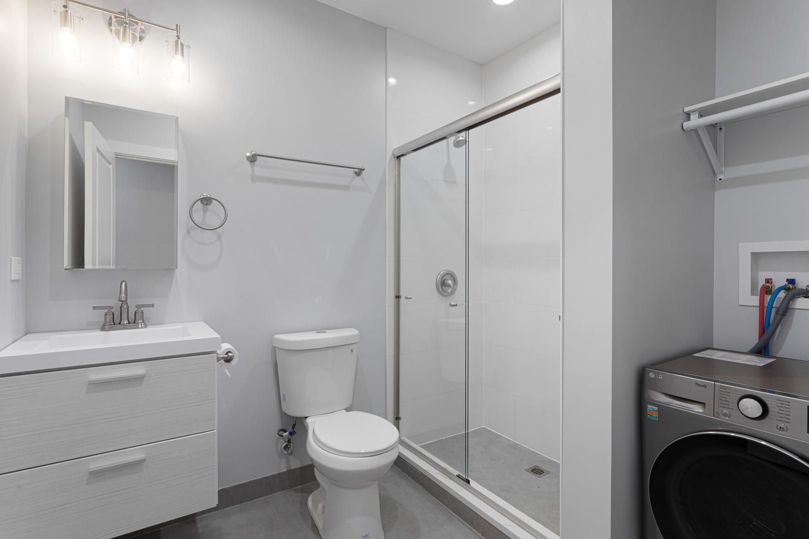 7381 North Damen Avenue, Unit 1E Chicago, IL 60645 - Photo 11 of 13 a bathroom with a toilet a sink and a shower
