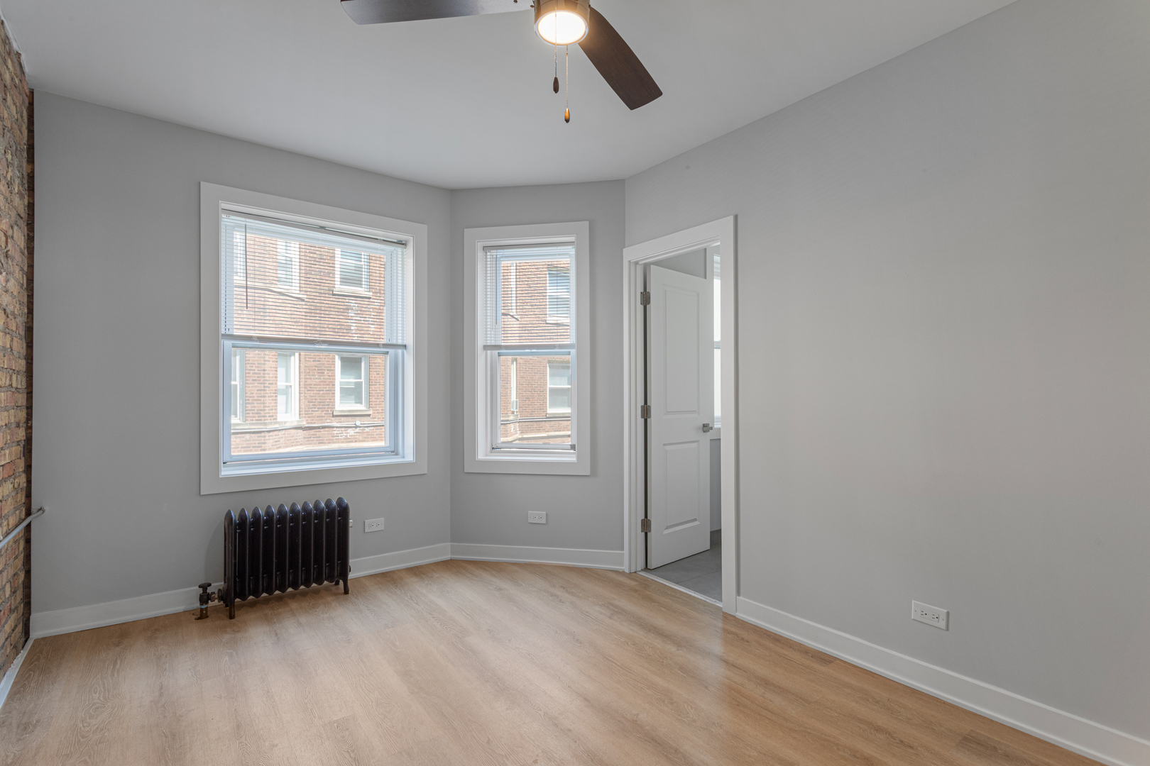 7381 North Damen Avenue, Unit 1E Chicago, IL 60645 - Photo 8 of 13 an empty room with windows