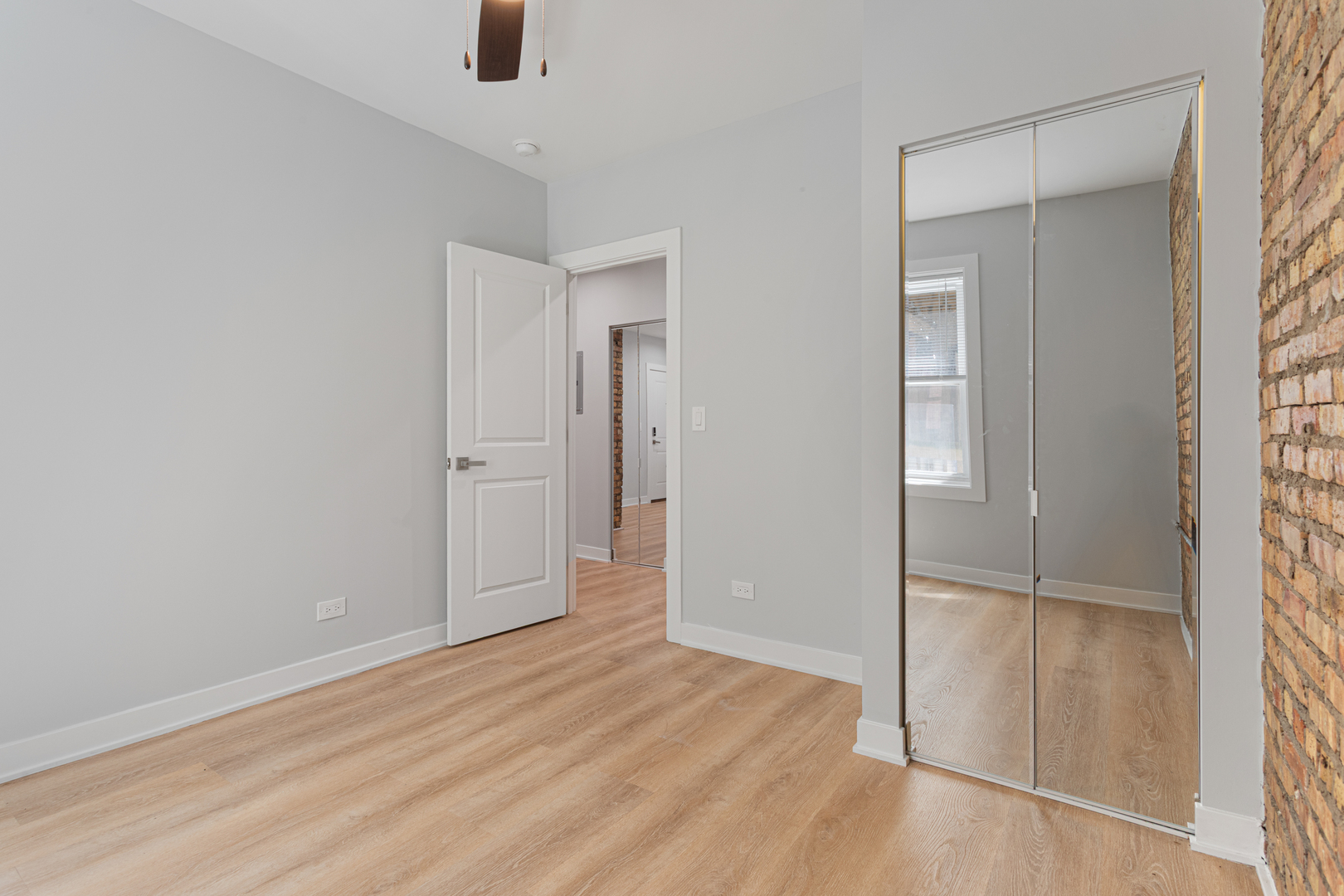 7381 North Damen Avenue, Unit 1E Chicago, IL 60645 - Photo 9 of 13 an empty room with windows and closet