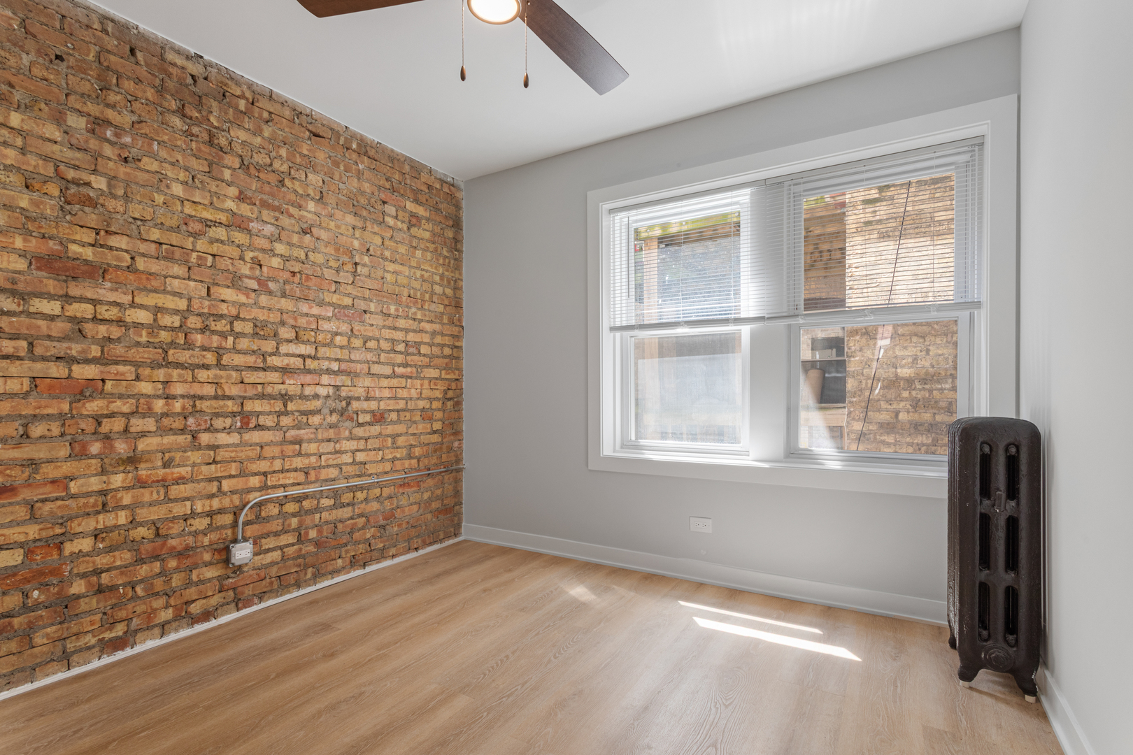 7381 North Damen Avenue, Unit 1E Chicago, IL 60645 - Photo 10 of 13 a view of an empty room with a window