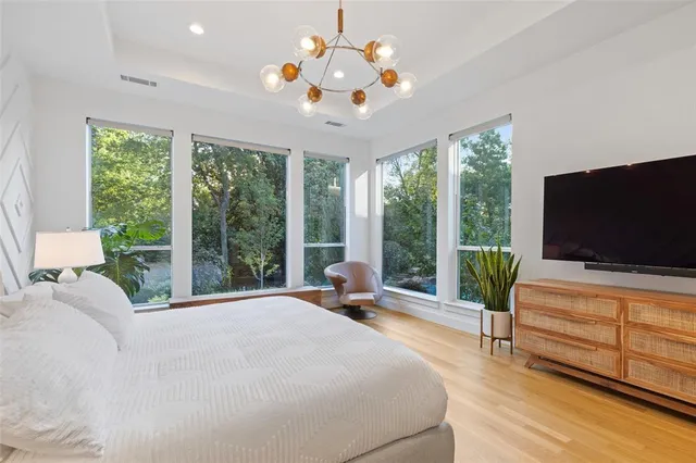 a bedroom with a bed and large flat screen tv