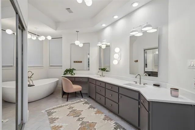 a spacious bathroom with a bathtub shower sink double and mirror