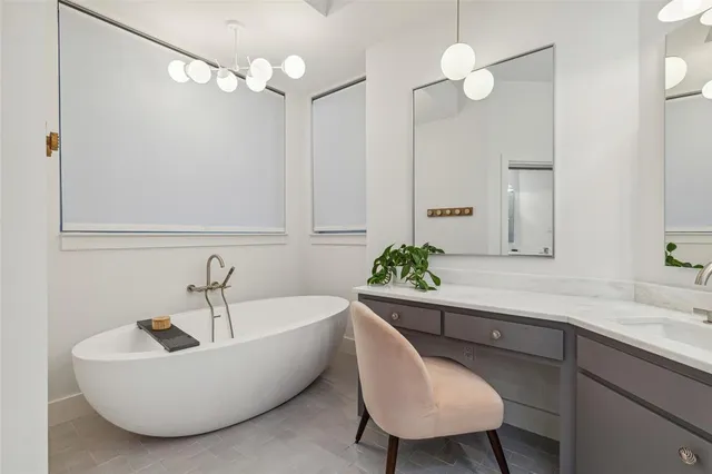 a living room with a couch and a chandelier