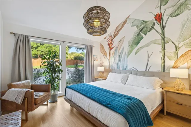 a bedroom with a bed and a large window