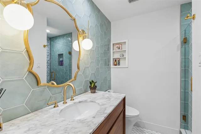 a bathroom with a granite countertop sink and a mirror