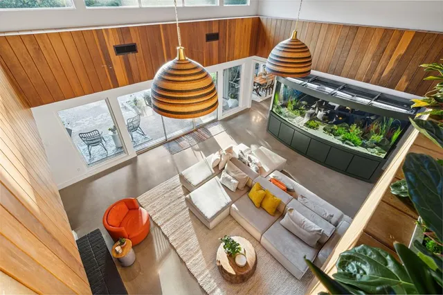 a front view of a house with swimming pool having outdoor seating