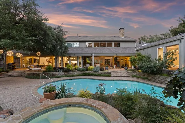 a view of a house with backyard and sitting area