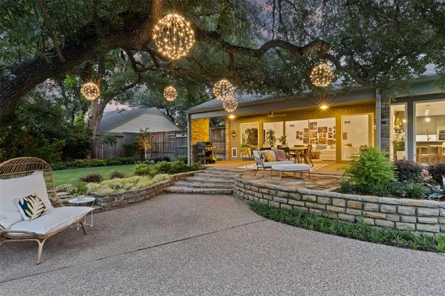 a view of a house with sitting area and garden
