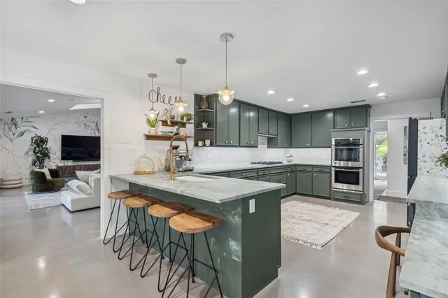 a large kitchen with a table and chairs in it