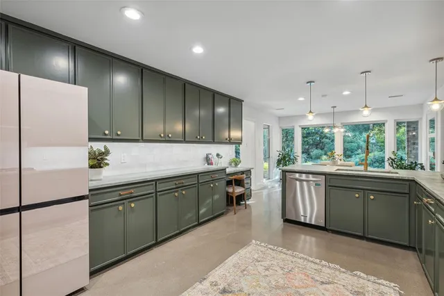 a kitchen with kitchen island granite countertop cabinets and white appliances
