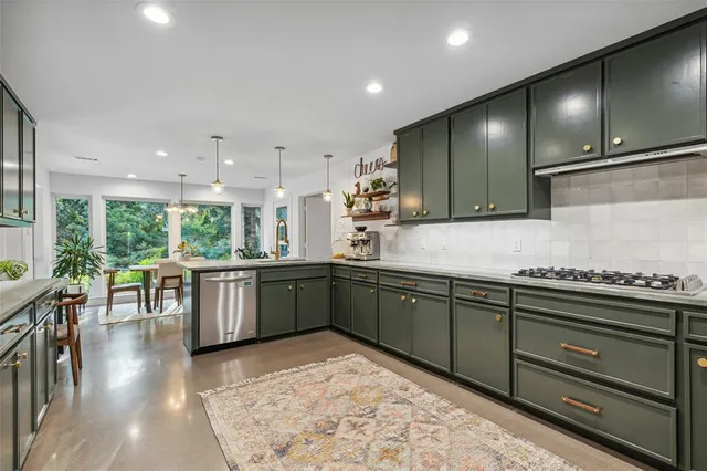 a kitchen with lots of counter top space and wooden floor