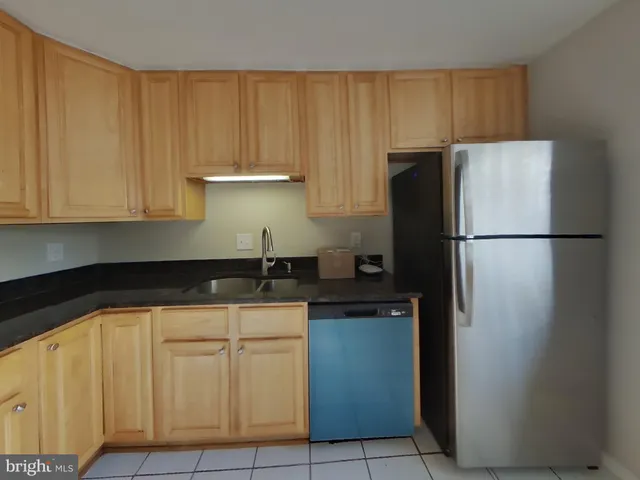 a kitchen with a refrigerator and cabinets