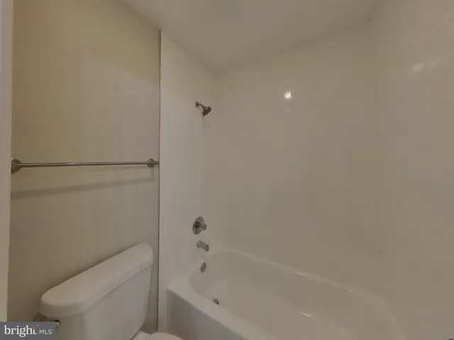 a bathroom with a toilet and bathtub