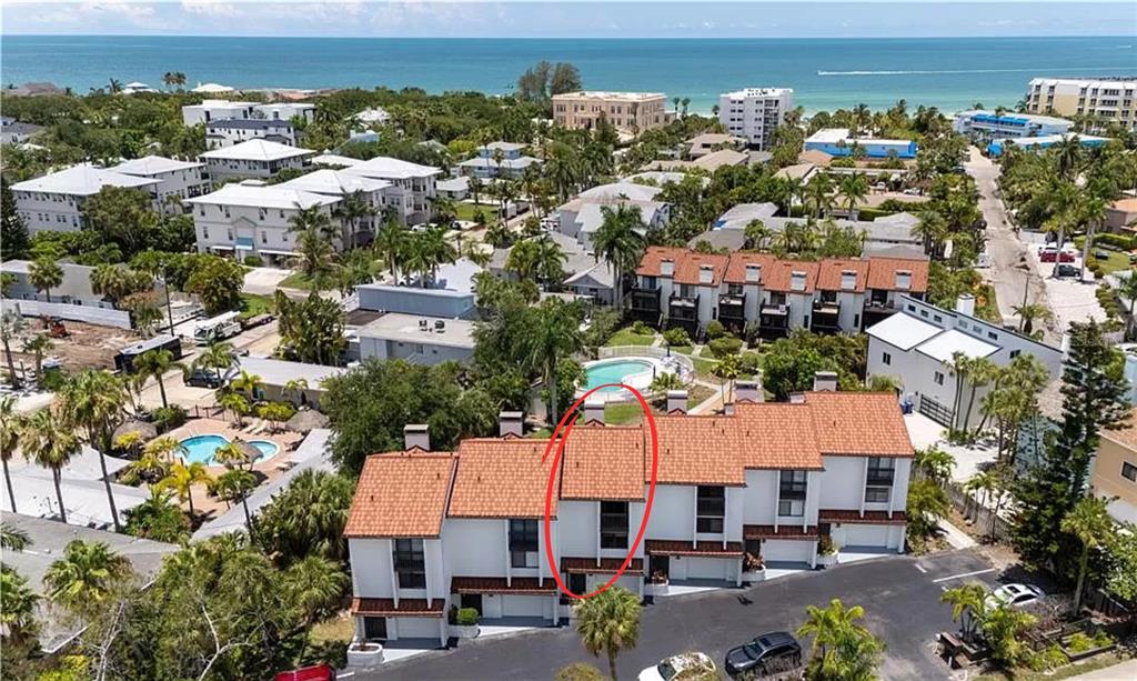 an aerial view of multiple houses with yard