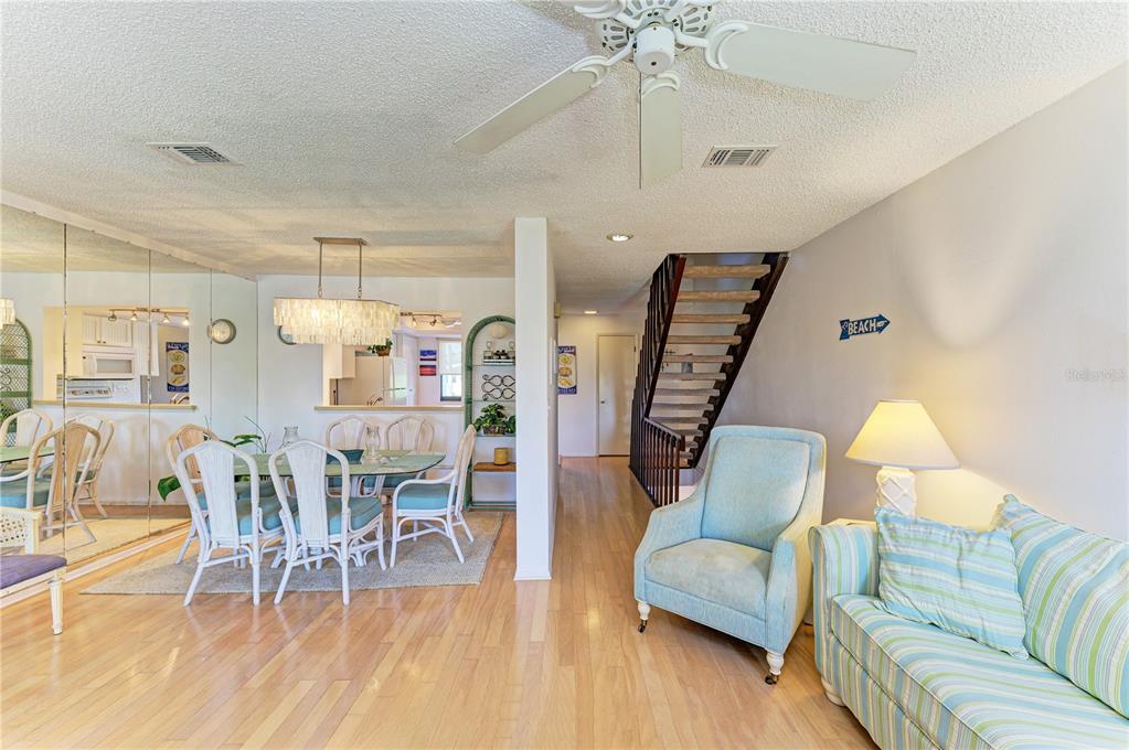 6840 Midnight Pass Road, Unit 6840 Sarasota, FL 34242 - Photo 11 of 66 a living room with furniture and a wooden floor
