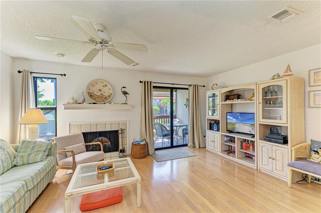 6840 Midnight Pass Road, Unit 6840 Sarasota, FL 34242 - Photo 14 of 66 a living room with furniture and a fireplace